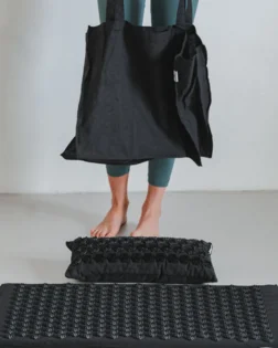 Linen acupressure mat with neck pillow and pressure point discs for targeted support.