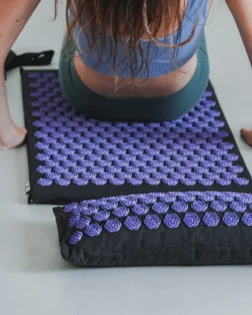 Classic linen acupressure mat and pillow with pressure point discs for back and neck relief.