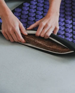 Classic linen acupressure mat and pillow with pressure point discs for back and neck relief.