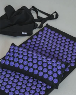 Classic linen acupressure mat and pillow with pressure point discs for back and neck relief.