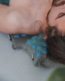 Linen acupressure mat with small pillow and pressure point discs for neck and shoulder support.