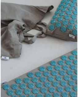 Linen acupressure mat with small pillow and pressure point discs for neck and shoulder support.