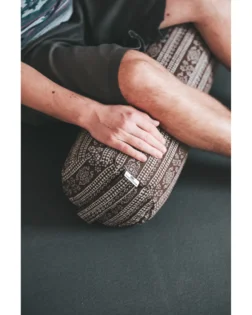 Brown print yoga bolster with buckwheat hulls and cotton cover, support for restorative yoga.