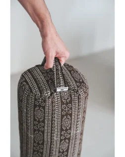 Brown print yoga bolster with buckwheat hulls and cotton cover, support for restorative yoga.