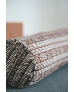 Brown print yoga bolster with buckwheat hulls and cotton cover, support for restorative yoga.