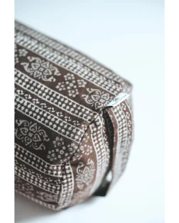 Brown print yoga bolster with buckwheat hulls and cotton cover, support for restorative yoga.