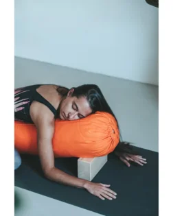 Orange organic cotton bolster pillow filled with cotton for support and comfort