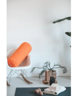 Orange organic cotton bolster pillow filled with cotton for support and comfort