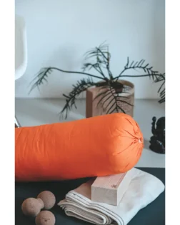 Orange organic cotton bolster pillow filled with cotton for support and comfort