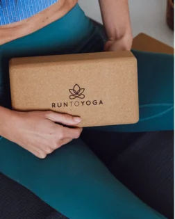 Small cork yoga block for hand support and stability in yoga poses.